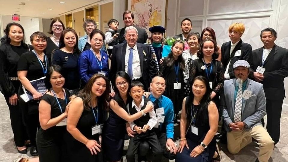Colleagues, family and community members together at a formal graduation gathering