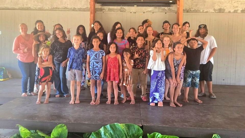 Keiki and youth at a 2026 summer camp in Hawaiʻi, gathered on an open-air stage