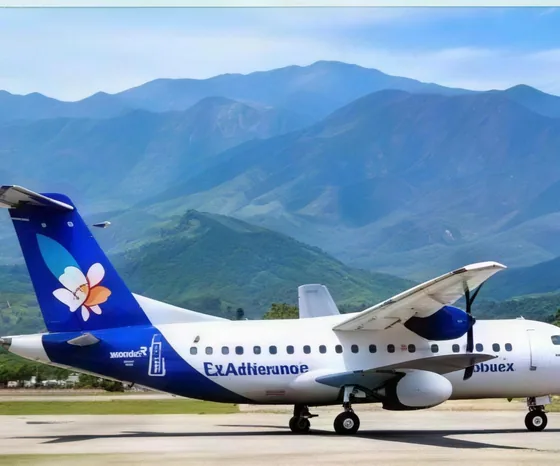 A turboprop aircraft on the tarmac with mountains behind