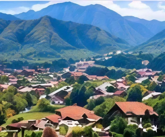 A hillside town under green mountains