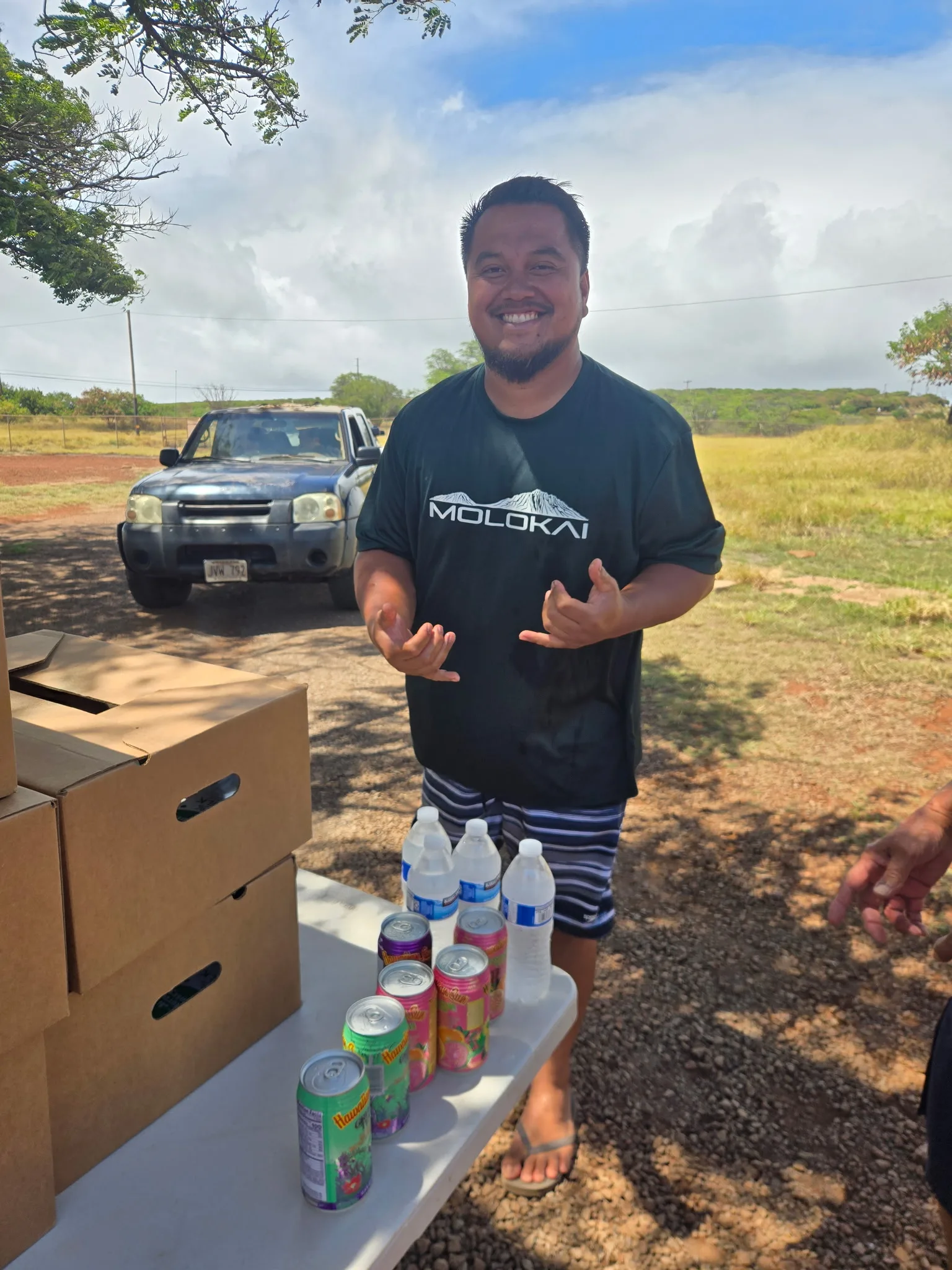 A volunteer greets families at the pickup table.